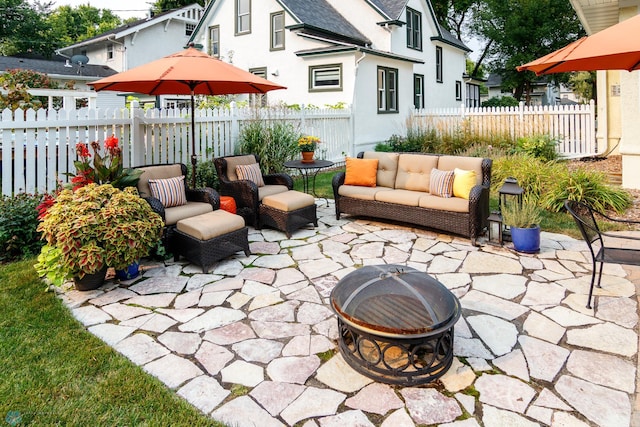 view of patio / terrace featuring an outdoor living space with a fire pit