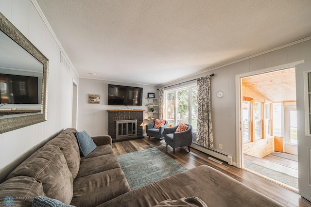 living room with crown molding, hardwood / wood-style flooring, and baseboard heating