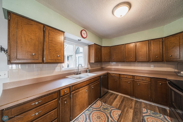 kitchen with sink, a textured ceiling, black electric range oven, stainless steel dishwasher, and dark hardwood / wood-style floors