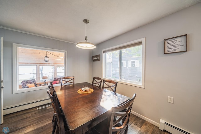 dining space featuring a baseboard heating unit and dark hardwood / wood-style floors