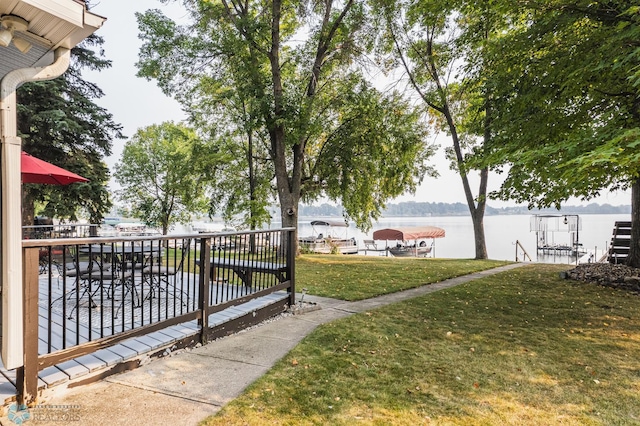 view of home's community with a yard and a water view