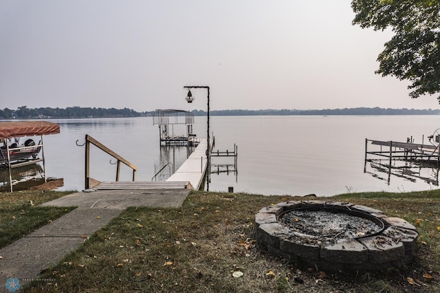 view of dock featuring a water view and a fire pit