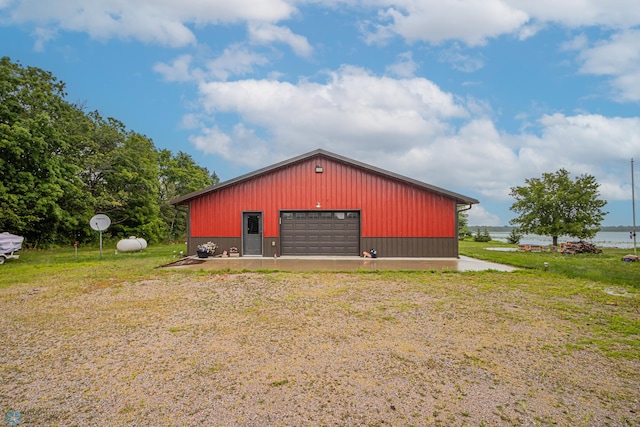 view of outdoor structure featuring a yard and a garage