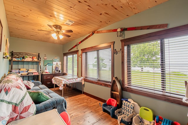 bedroom featuring light wood-type flooring, vaulted ceiling, ceiling fan, and wooden ceiling