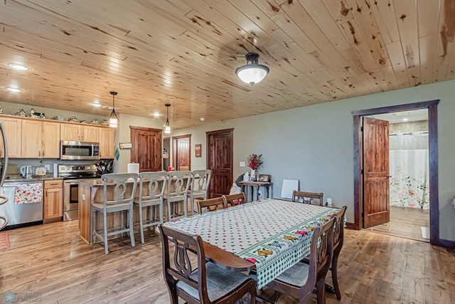 dining space with wooden ceiling and light hardwood / wood-style flooring