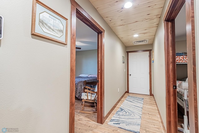 hall featuring light hardwood / wood-style flooring and wood ceiling