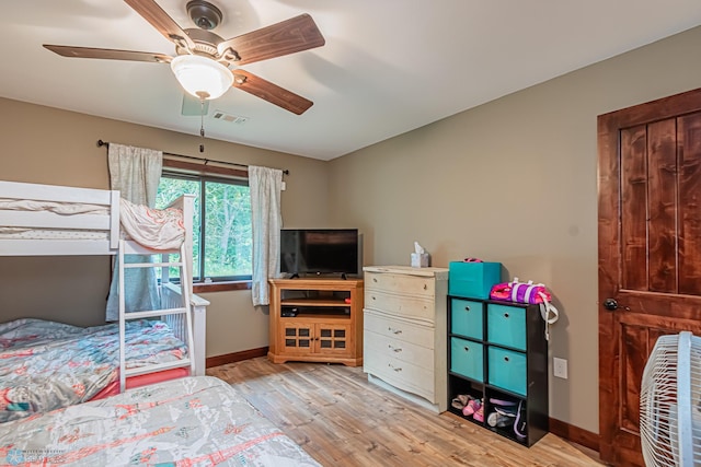 bedroom with light hardwood / wood-style floors and ceiling fan