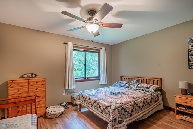 bedroom with wood-type flooring and ceiling fan