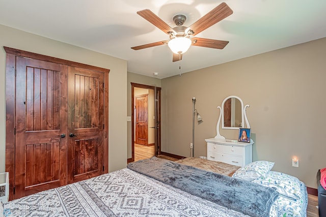 bedroom featuring wood-type flooring, ceiling fan, and a closet