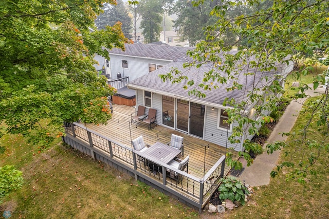 rear view of house featuring a wooden deck