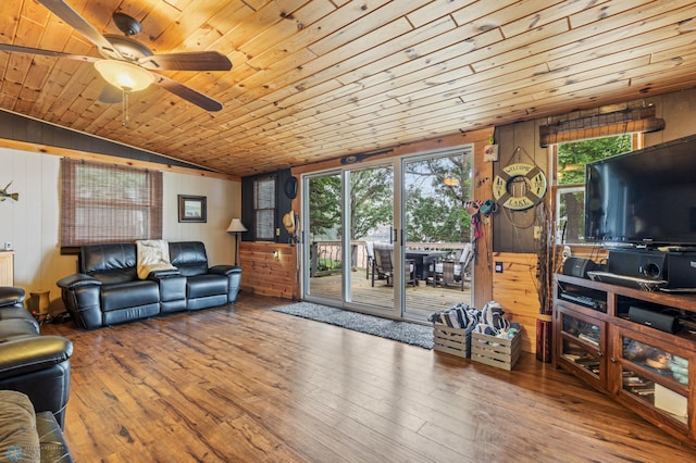 living room with a healthy amount of sunlight, wood ceiling, wood walls, and ceiling fan