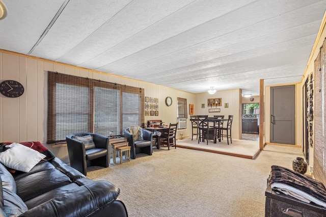 carpeted living room featuring a textured ceiling and wood walls