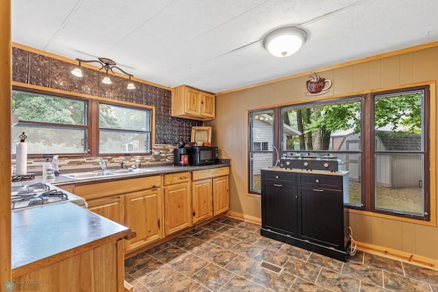 kitchen featuring stainless steel stove, a textured ceiling, sink, and tasteful backsplash