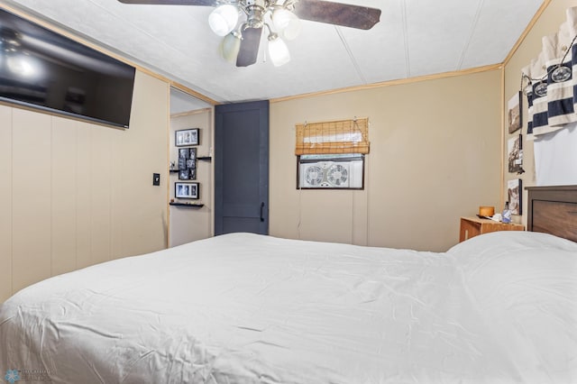 bedroom with ceiling fan and ornamental molding