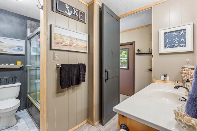 full bathroom with enclosed tub / shower combo, ornamental molding, vanity, and toilet