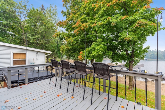 wooden terrace featuring a water view