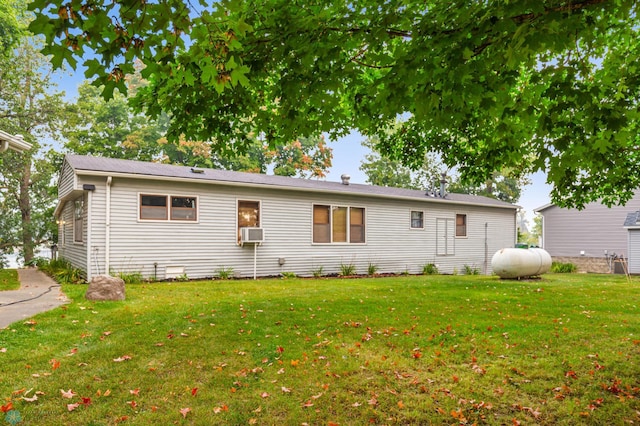 back of house featuring cooling unit and a yard