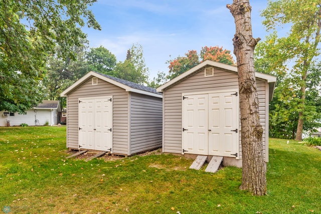 view of outbuilding featuring a lawn