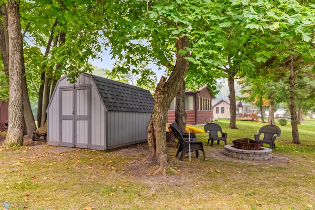 view of yard featuring a storage shed and a fire pit