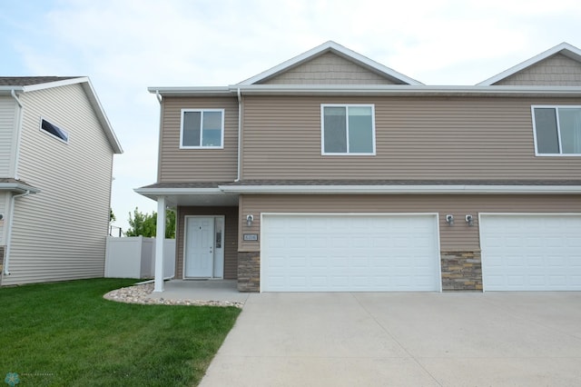 view of front of home featuring a front yard and a garage