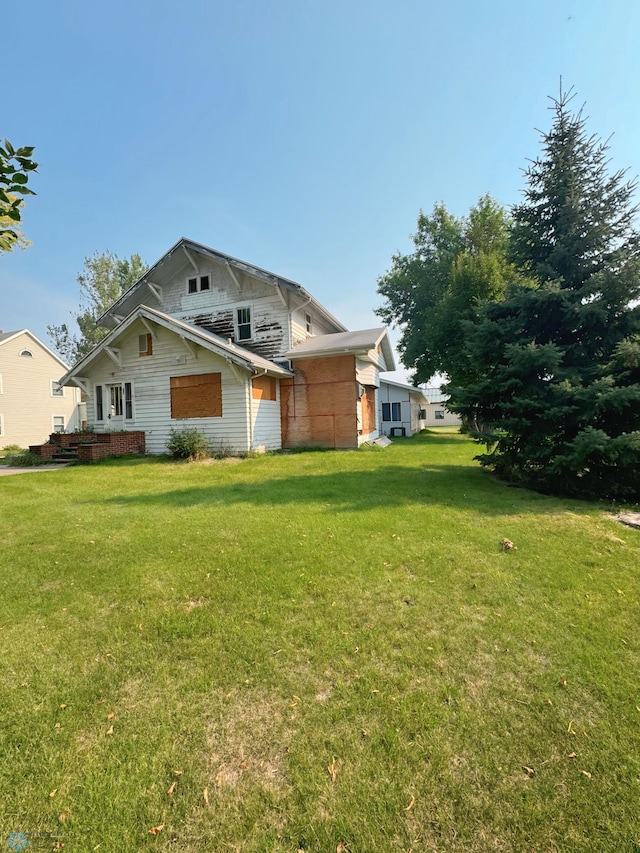 view of side of property with a yard and a wooden deck