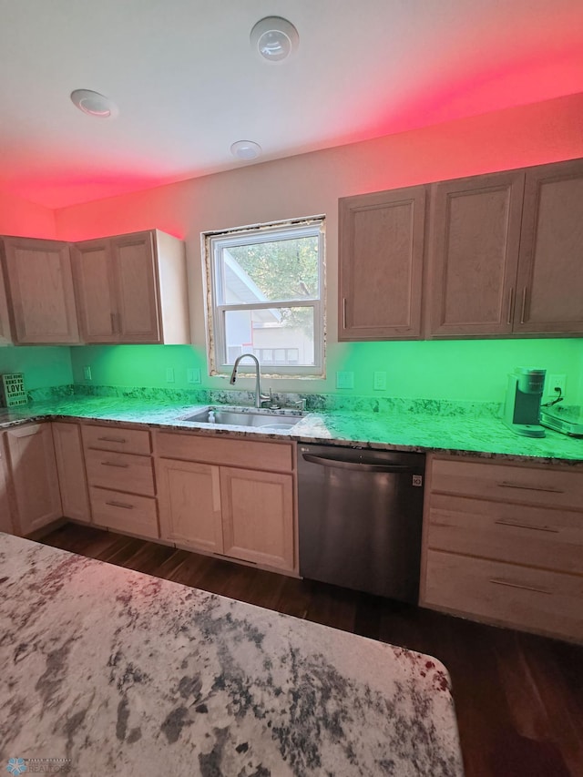 kitchen with dark hardwood / wood-style flooring, light brown cabinetry, light stone counters, sink, and stainless steel dishwasher