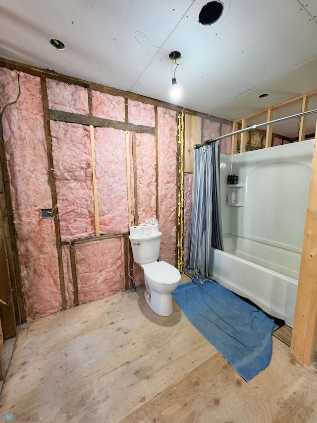 bathroom with toilet and shower / bath combination with curtain