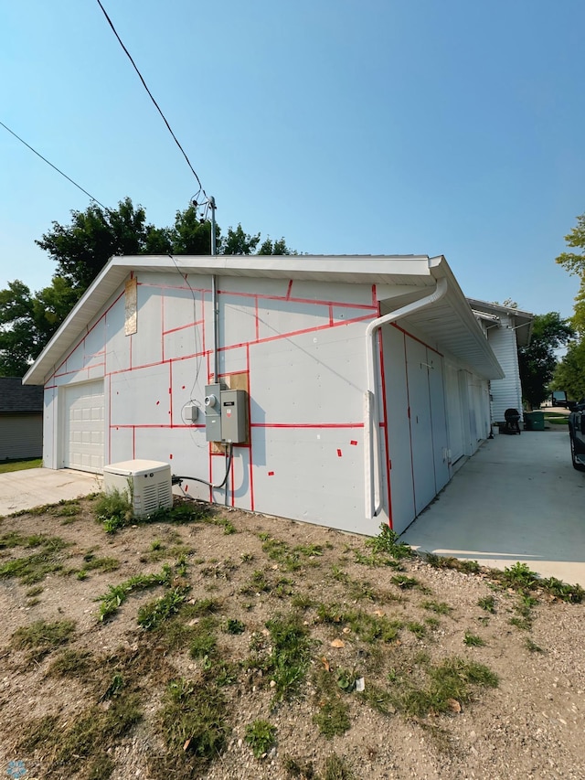 view of home's exterior with an outdoor structure and a garage