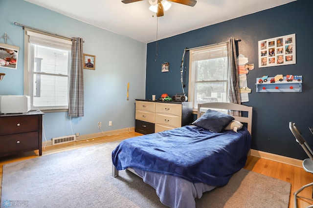 bedroom with light wood-type flooring and ceiling fan