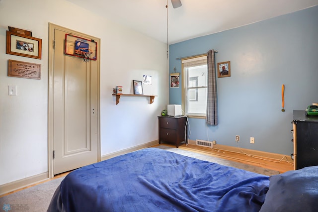 bedroom with light hardwood / wood-style flooring and ceiling fan