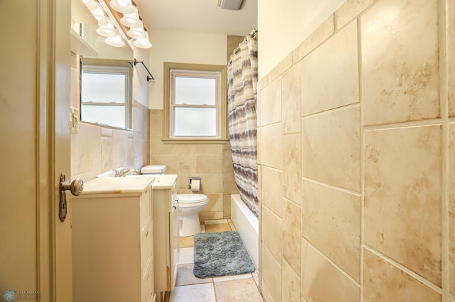 full bathroom with tile walls, toilet, shower / tub combo, and tile patterned floors