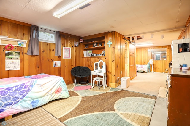 bedroom featuring wooden walls