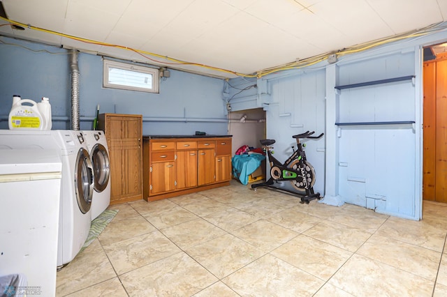 washroom with washer and dryer and cabinets