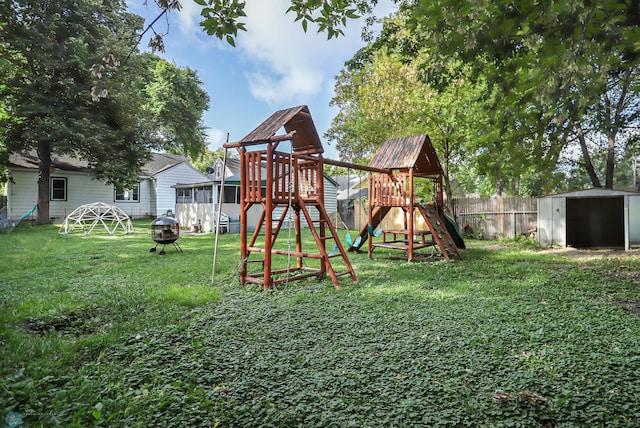 view of playground with a yard and a shed