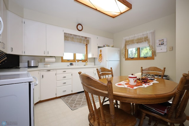 kitchen with white appliances and white cabinets