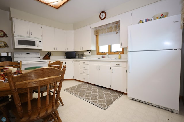 kitchen featuring white cabinets, white appliances, and sink