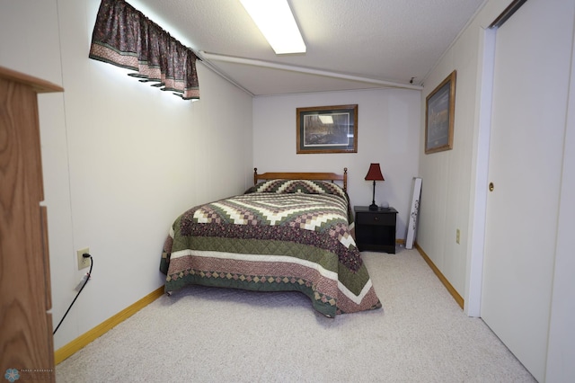 carpeted bedroom with ornamental molding and a textured ceiling