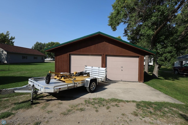 garage featuring a lawn and wooden walls