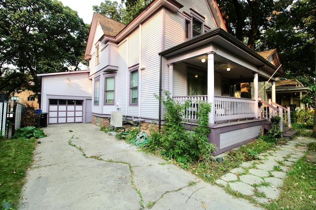 exterior space with covered porch and a garage