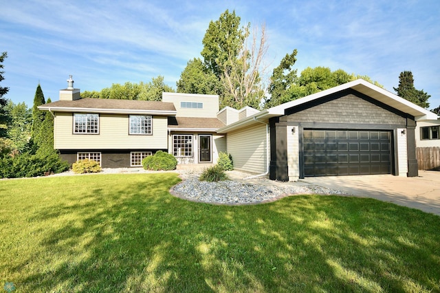 tri-level home with a garage and a front lawn