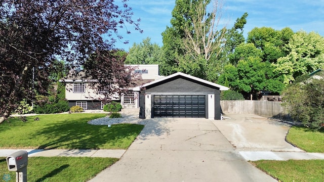 view of front of house with a front lawn and a garage