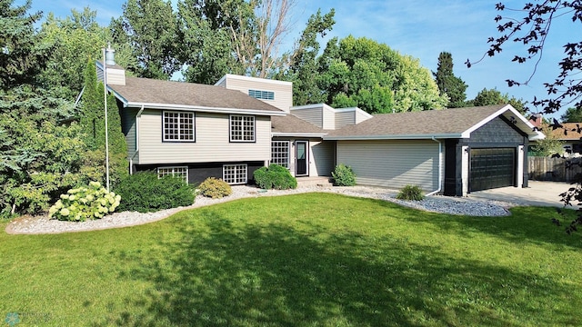 view of front of house with a garage and a front lawn