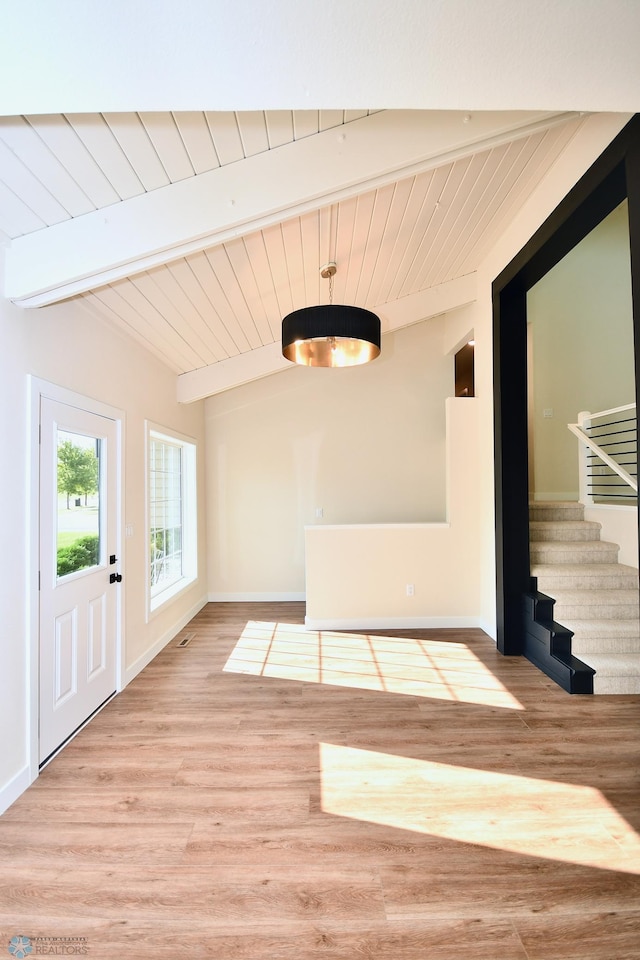 interior space with light hardwood / wood-style flooring, lofted ceiling with beams, and wood ceiling