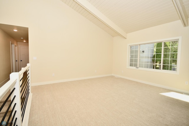 unfurnished room with vaulted ceiling with beams and light colored carpet