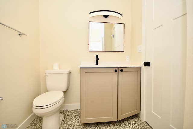 bathroom with vanity, toilet, and tile patterned floors