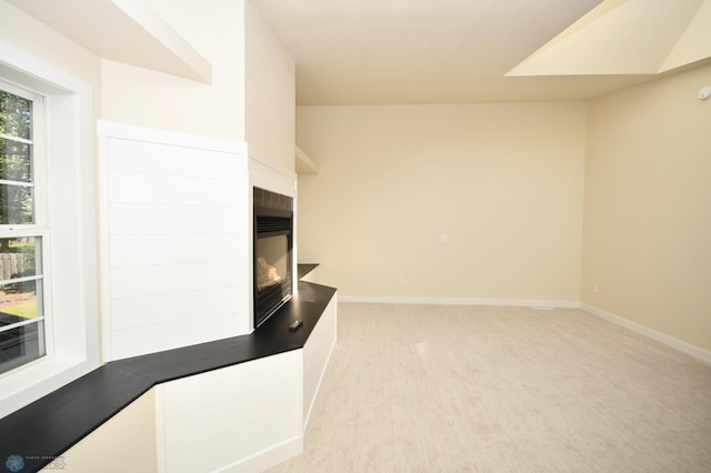 interior space with a multi sided fireplace and carpet