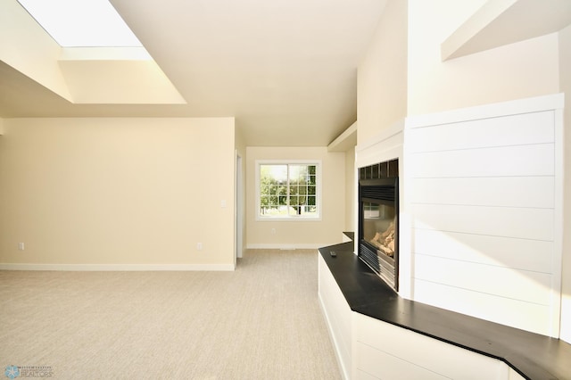 unfurnished living room featuring light colored carpet