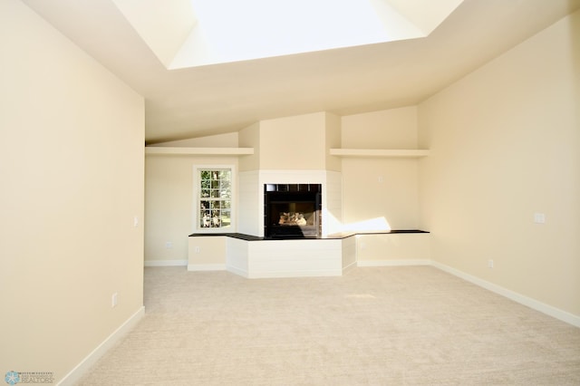 unfurnished living room featuring light carpet, a multi sided fireplace, and vaulted ceiling