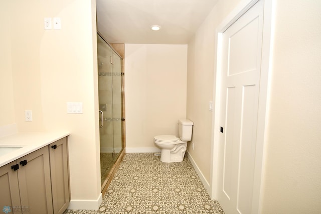 bathroom with an enclosed shower, vanity, and toilet