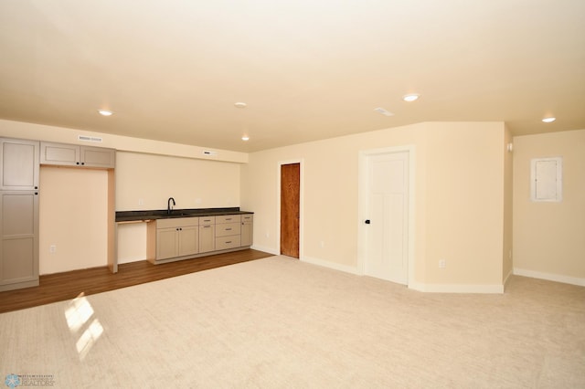 empty room with hardwood / wood-style floors and sink